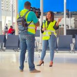 A man filming a reporter at the ‘Airport Safety & Security Week’