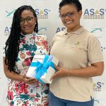 Two employees of Curaçao National Airport receiving a gift at the ‘Airport Safety & Security Week’